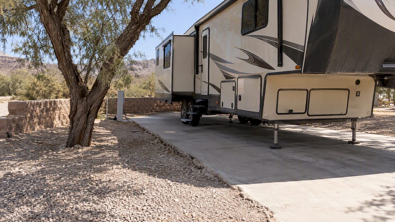 RV site with tree and retaining wall