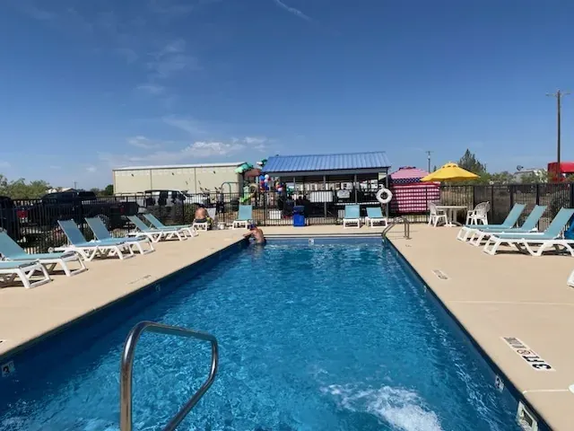 Pool deck and shade structures at Mesquite Oasis Lodge & RV Park in Odessa, Texas